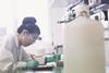 Female scientist in laboratory doing calculations