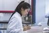 Female scientist reading documents in lab