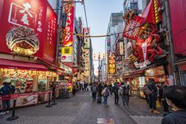 A crowd of people walking in night shopping street at Dotonbori, Osaka, Japan