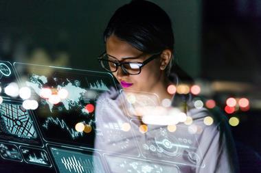 Person analysing data and trends on transparent screens