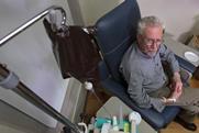 A photo of an elderly man receiving treatment via an IV drip