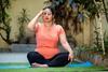 An image showing an Indian woman practicing pranayama