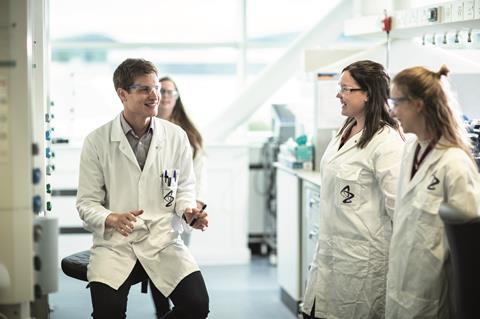 Scientists talking and laughing in a laboratory