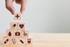 Stacking wooden blocks printed with healthcare-related icons