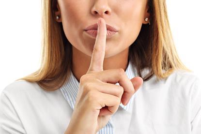 Woman making a hush sign