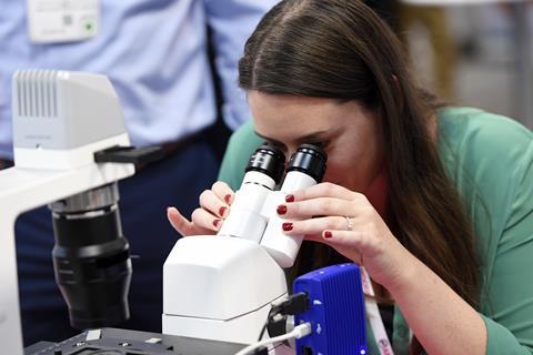 Woman looking through microscope