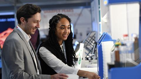 Man and woman checking a stand