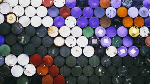 An aerial view of many colourful petroleum barrels