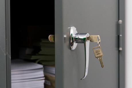 A key has opened a locker containing papers and books