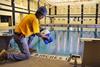 Man adding chlorine to a pool